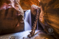 Hiking through the red rock slot canyons in Kanarraville, Utah.