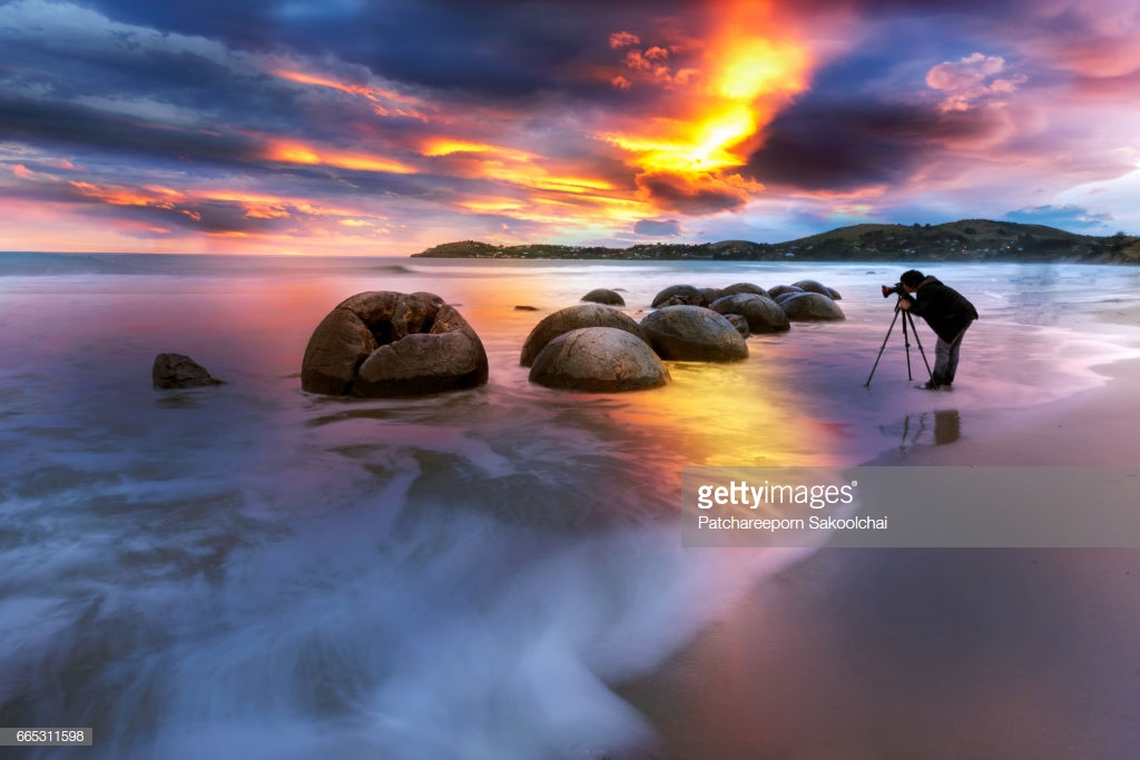 profesional photographer taken photo at Moeraki Boulders on the Koekohe beach, Eastern coast of New Zealand. Sunset and long exposure