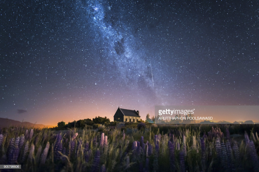 Church of The Good Shepherd and Milky Way with lupins blooming, Lake Tekapo, New Zealand