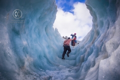 Travelers explore New Zealand's famous Franz Josef Glacier. Blue Ice, deep crevasses, caves and tunnels mark the ever changing ice.