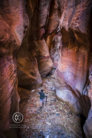 Hiking through the red rock slot canyons in Kanarraville, Utah.