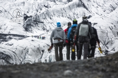 A group hikes through the Solheimajokull glacier.