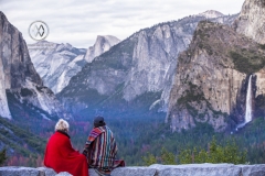 Girls watch the sun set over the Yosemite Valley.