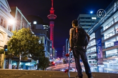 The illuminated Auckland Sky Tower during a colorful evening sunset