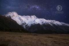 The snowy mountain peaks of the Mount Cook National Park sits under starry skies.