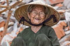 Bai Xep is a quiet remote fishing village off the tourist path, 10km from the major city of Qui Nhon. A tourist meets a local woman hard at work in the village.