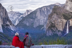 Girls watch the sun set over the Yosemite Valley.