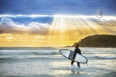 A beautiful sunrise greets surfers as they prepare and paddle out for an early morning surf.