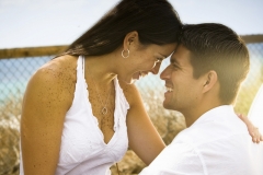 A young couple poses for portraits on the beach in Encinitas, California.