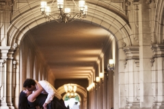 A couple embraces and dances in the middle of a beautiful hallway at Balboa Park in San Diego, California.