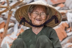 Bai Xep is a quiet remote fishing village off the tourist path, 10km from the major city of Qui Nhon. A tourist meets a local woman hard at work in the village.