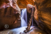 Hiking through the red rock slot canyons in Kanarraville, Utah.