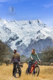 People ride bikes through the Mount Cook National Park.