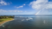A rainbow over the Hawaiian surf.