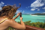 Sailing through the Whitsunday Islands to the white silica sands of Whitehaven Beach is a popular activity in Australia. A woman takes in the beautiful view.