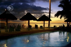 Viti Levu, Fiji. A poolside sunset for backpackers as they sip down their drinks.