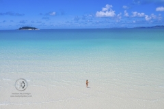 Sailing through the Whitsunday Islands to the white silica sands of Whitehaven Beach is a popular activity in Australia. Friends sit in the warm clear waters.