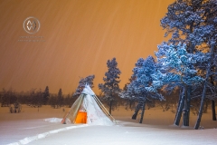 A native Sami Tipi tent sits in a blanket of snow.