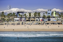 After a heavy snowfall in the Southern California mountains in February 2019, the snowcapped mountains show the close proximity to the beach. Often surfing and snowboarding can be done in the same day.
