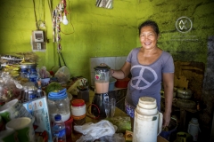 A local woman shows off her restaurant or "warung" on Serangan Beach, Bali.