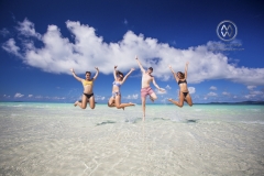 Sailing through the Whitsunday Islands to the white silica sands of Whitehaven Beach is a popular activity in Australia. Friends play on the beach.