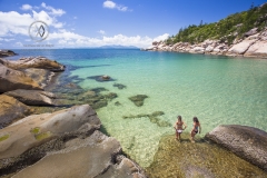 Alma Bay is one of the many beautiful beaches on Magnetic Island. Girls explore the clear waters.